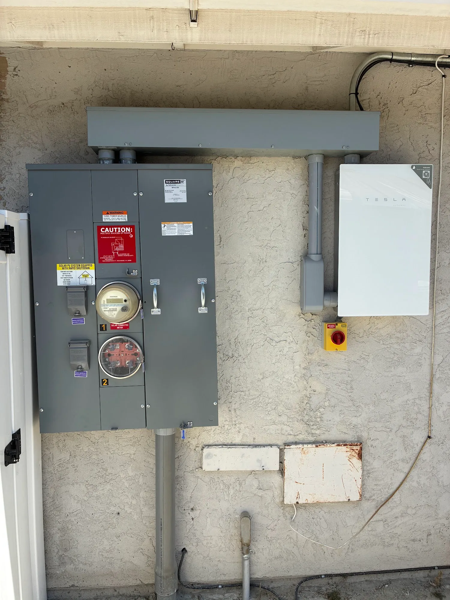 Meter and panel with a new equipment cabinet on an exterior wall