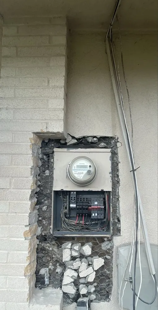 Meter and panel mid-replacement in a brick wall